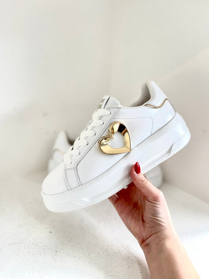 White sneaker with gold heart