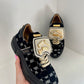 Black sneaker with gold details