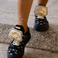 Black sneaker with gold details