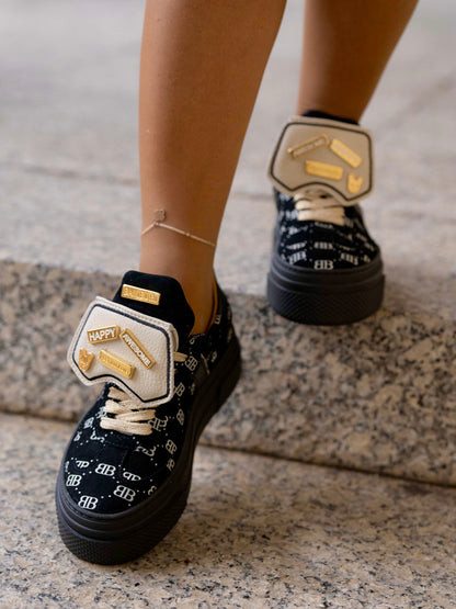 Black sneaker with gold details