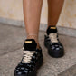 Black sneaker with gold details