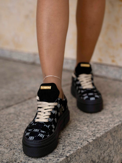 Black sneaker with gold details