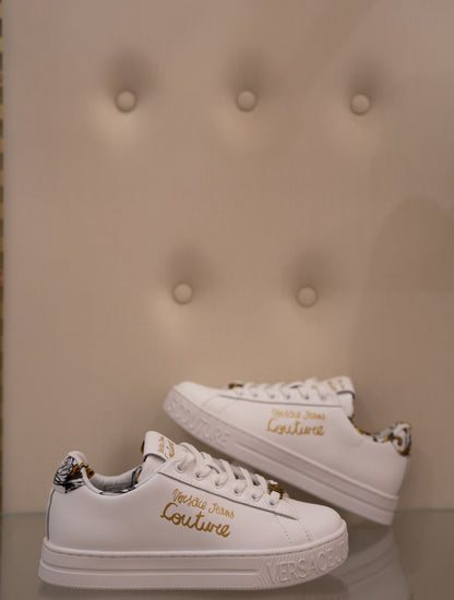 White sneaker with gold lettering