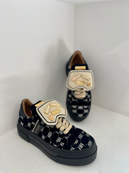 Black sneaker with gold details