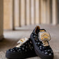 Black sneaker with gold details