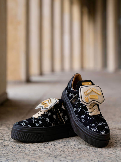 Black sneaker with gold details