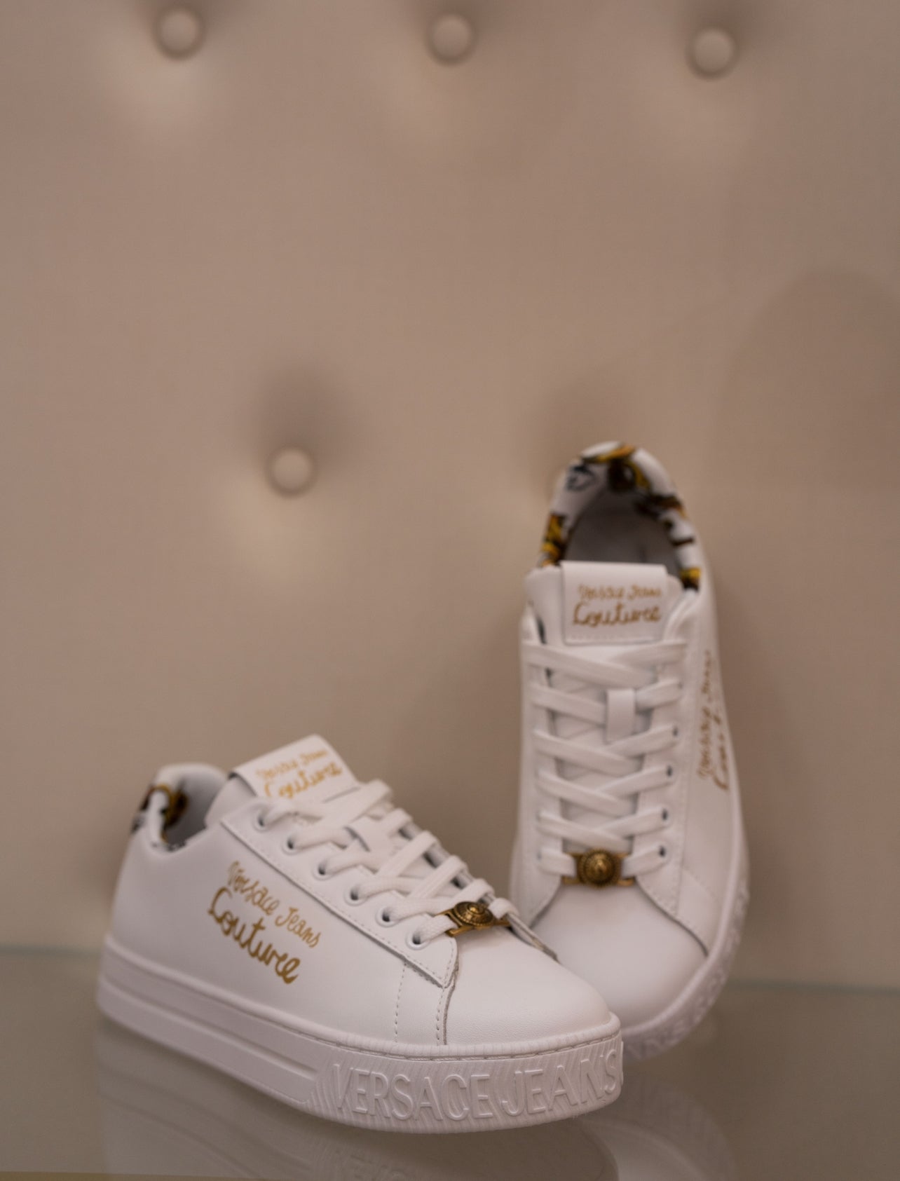 White sneaker with gold lettering