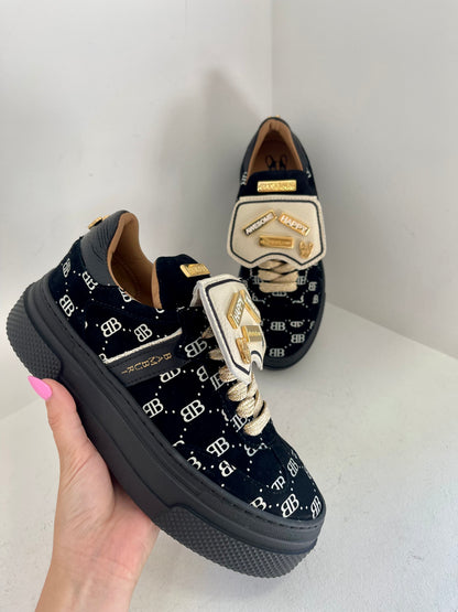 Black sneaker with gold details