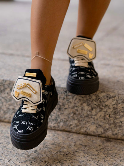 Black sneaker with gold details