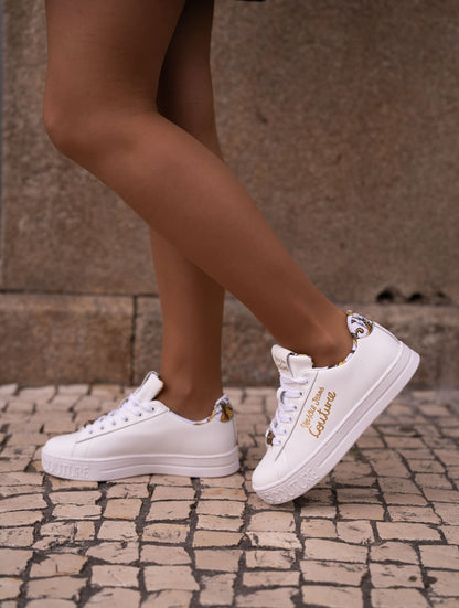 White sneaker with gold lettering