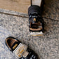 Black sneaker with gold details