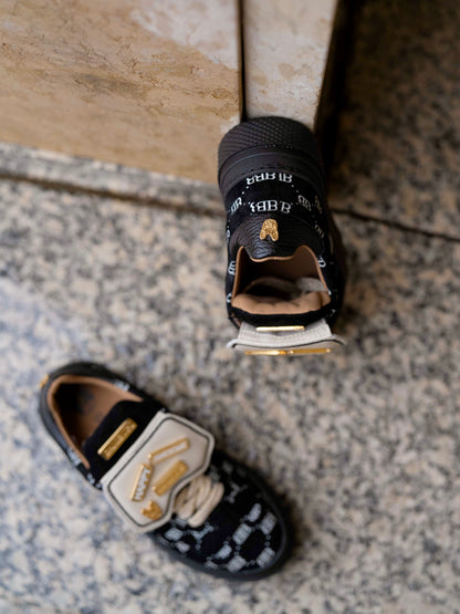 Black sneaker with gold details