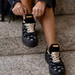 Black sneaker with gold details