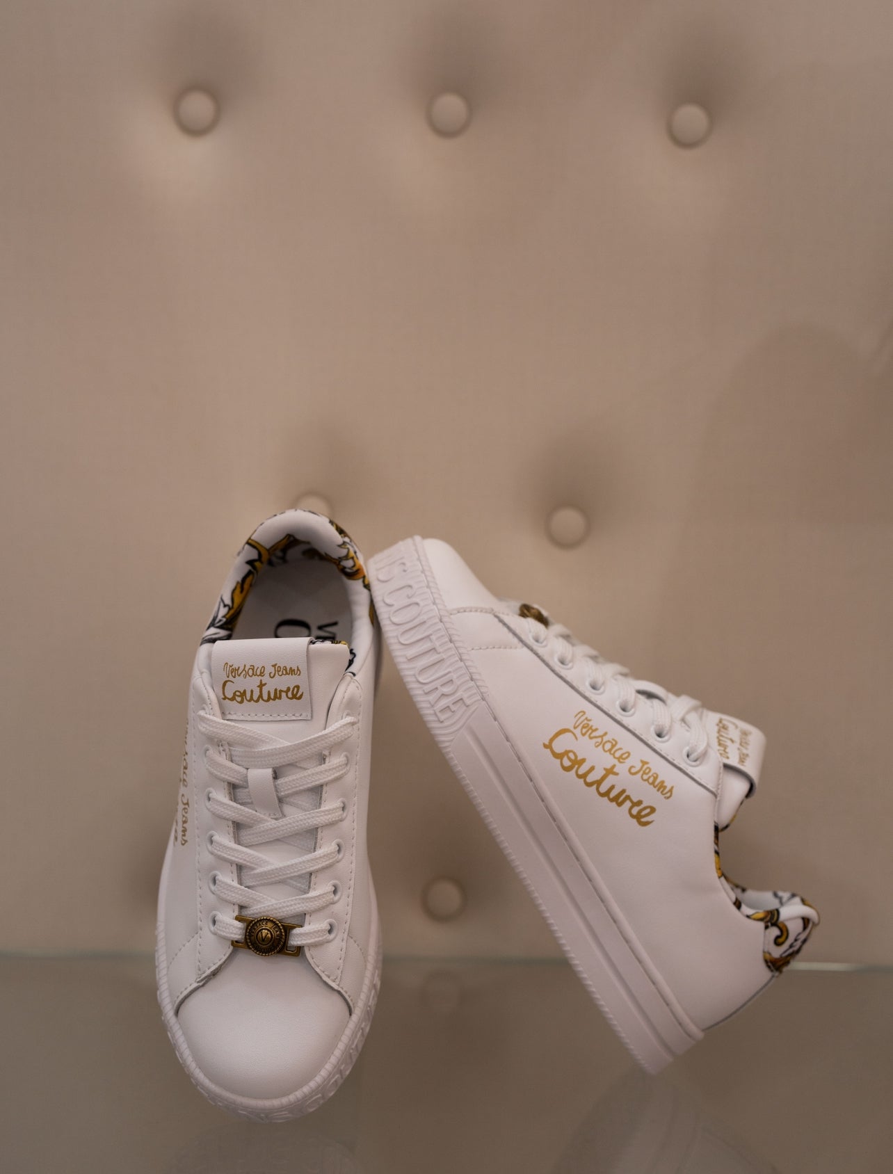 White sneaker with gold lettering