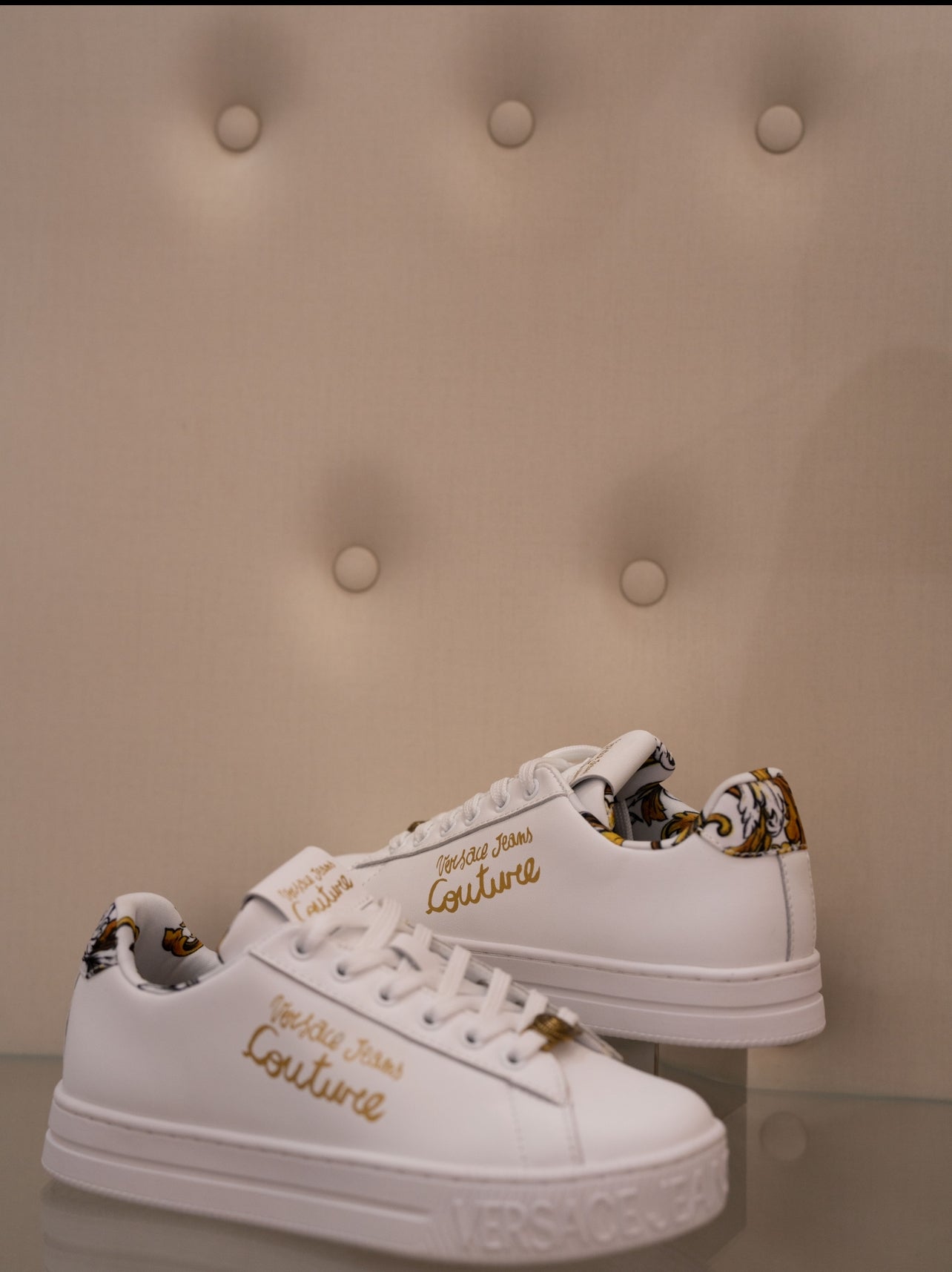 White sneaker with gold lettering