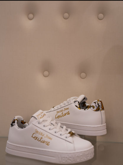 White sneaker with gold lettering