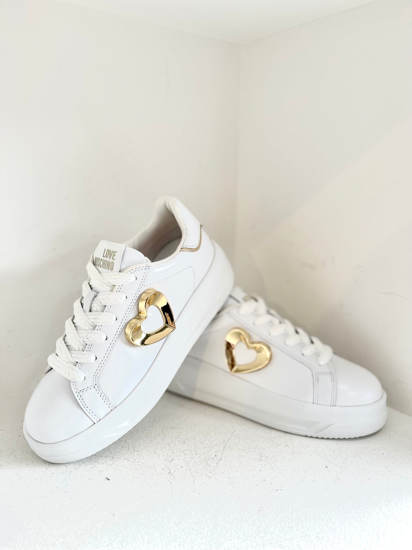 White sneaker with gold heart