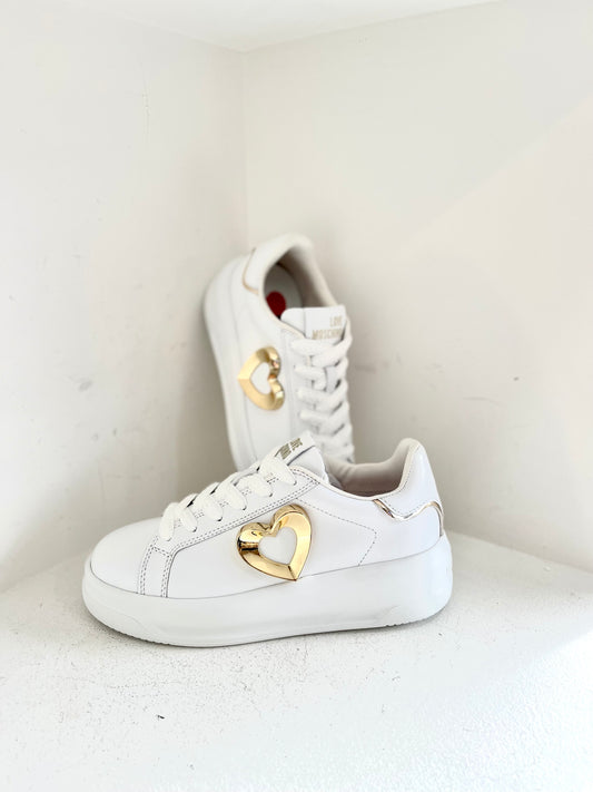 White sneaker with gold heart