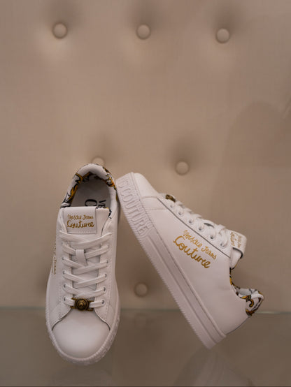 White sneaker with gold lettering