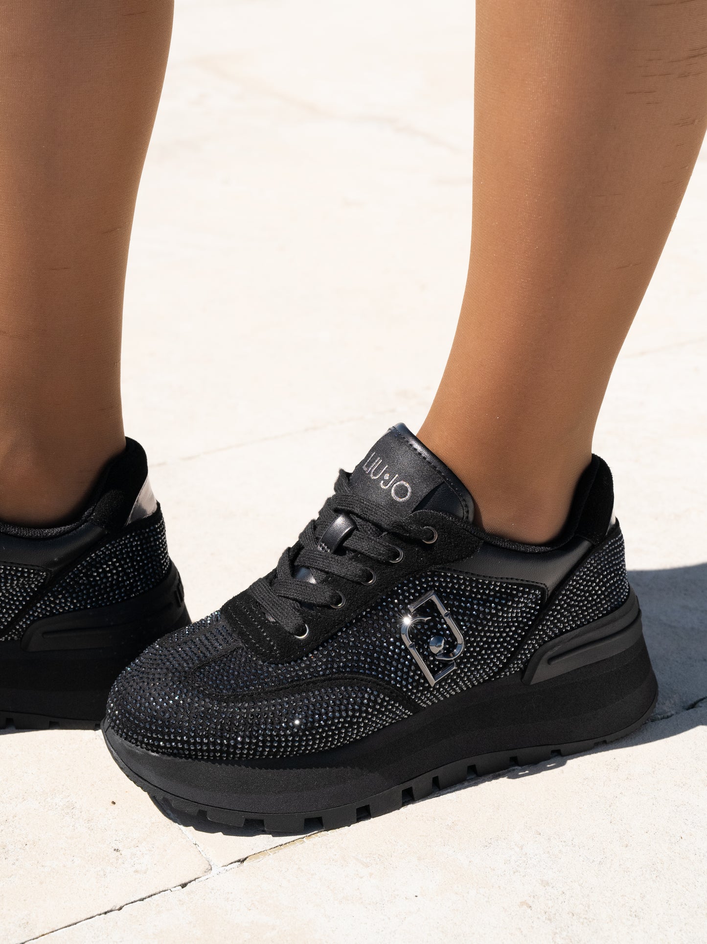 Black sneakers with all-over rhinestones