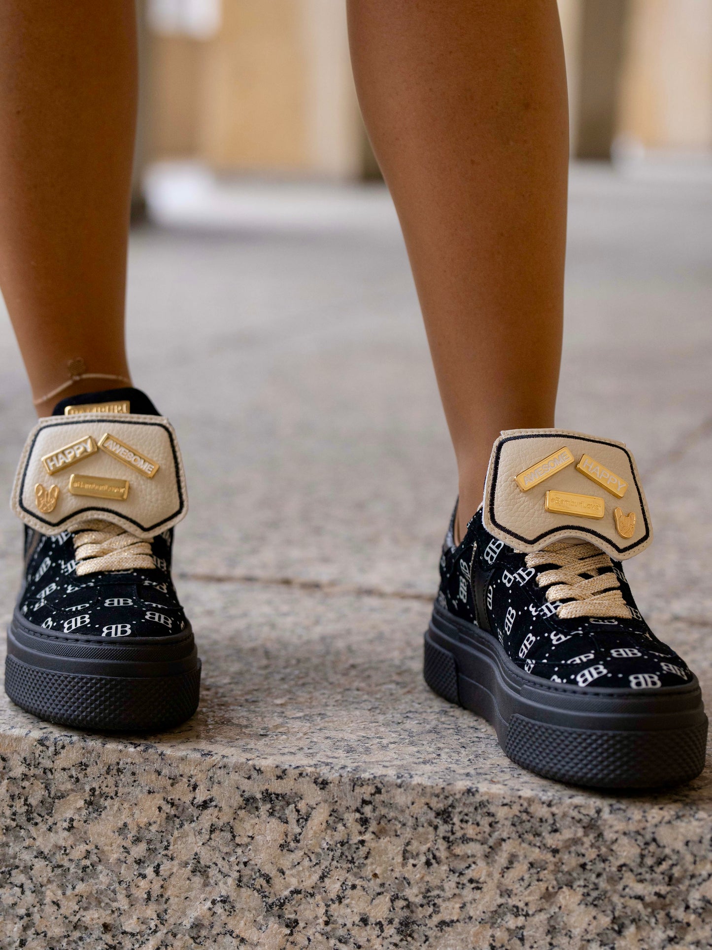 Black sneaker with gold details