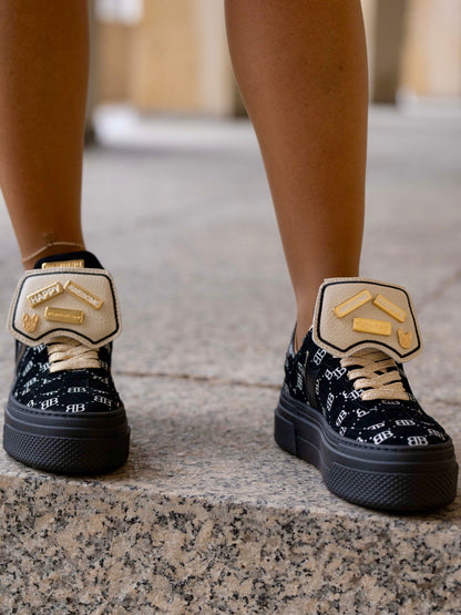 Black sneaker with gold details