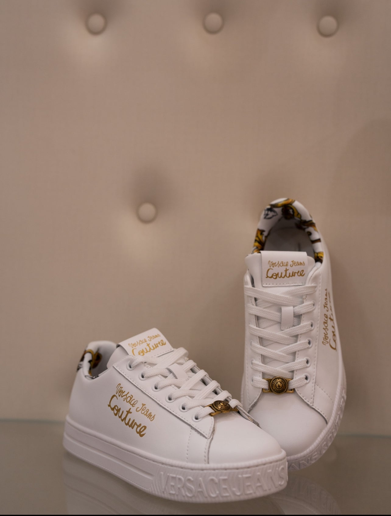 White sneaker with gold lettering