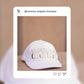 White cap with gold lettering