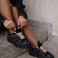 Black sneaker with gold details