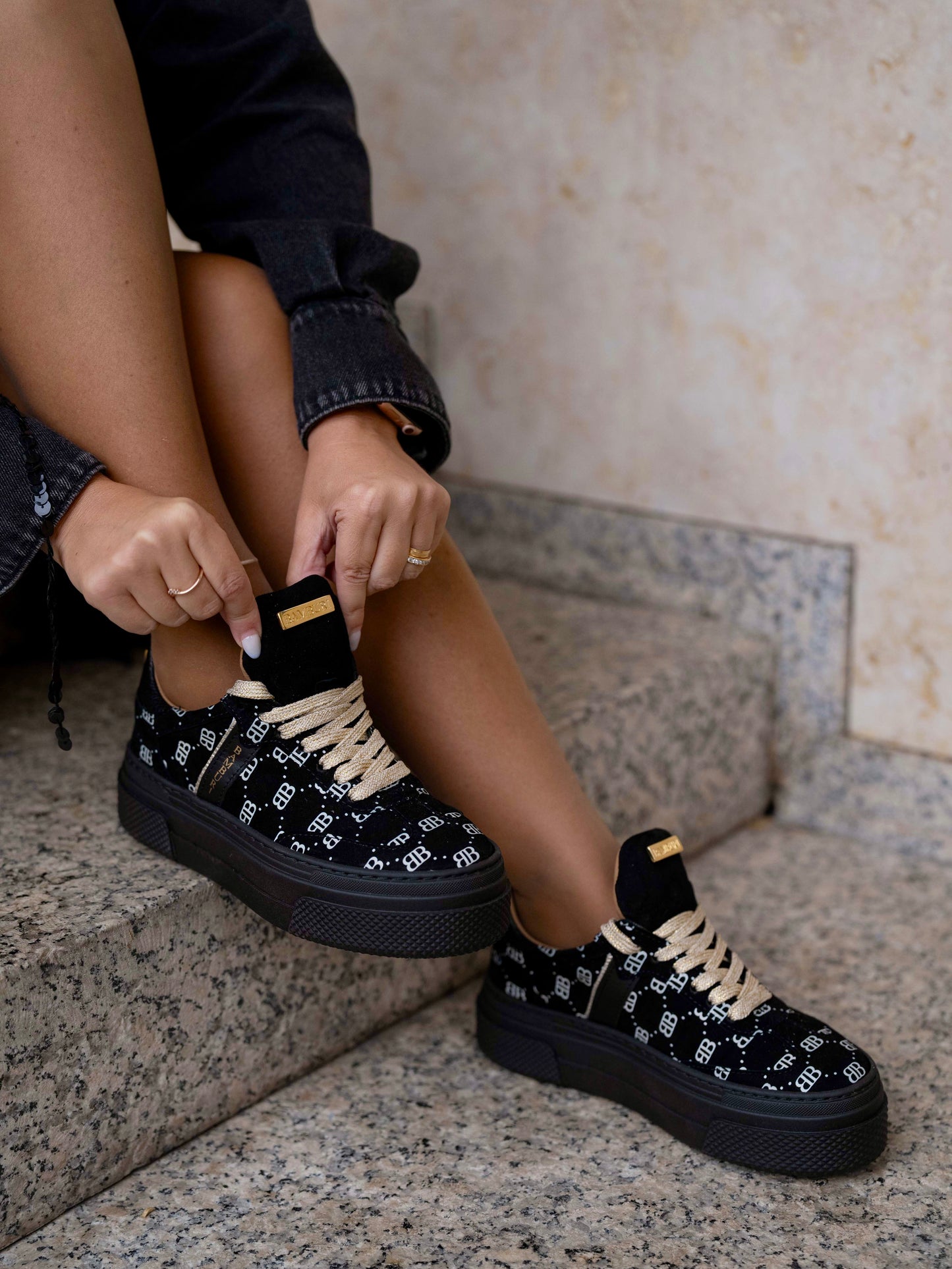 Black sneaker with gold details