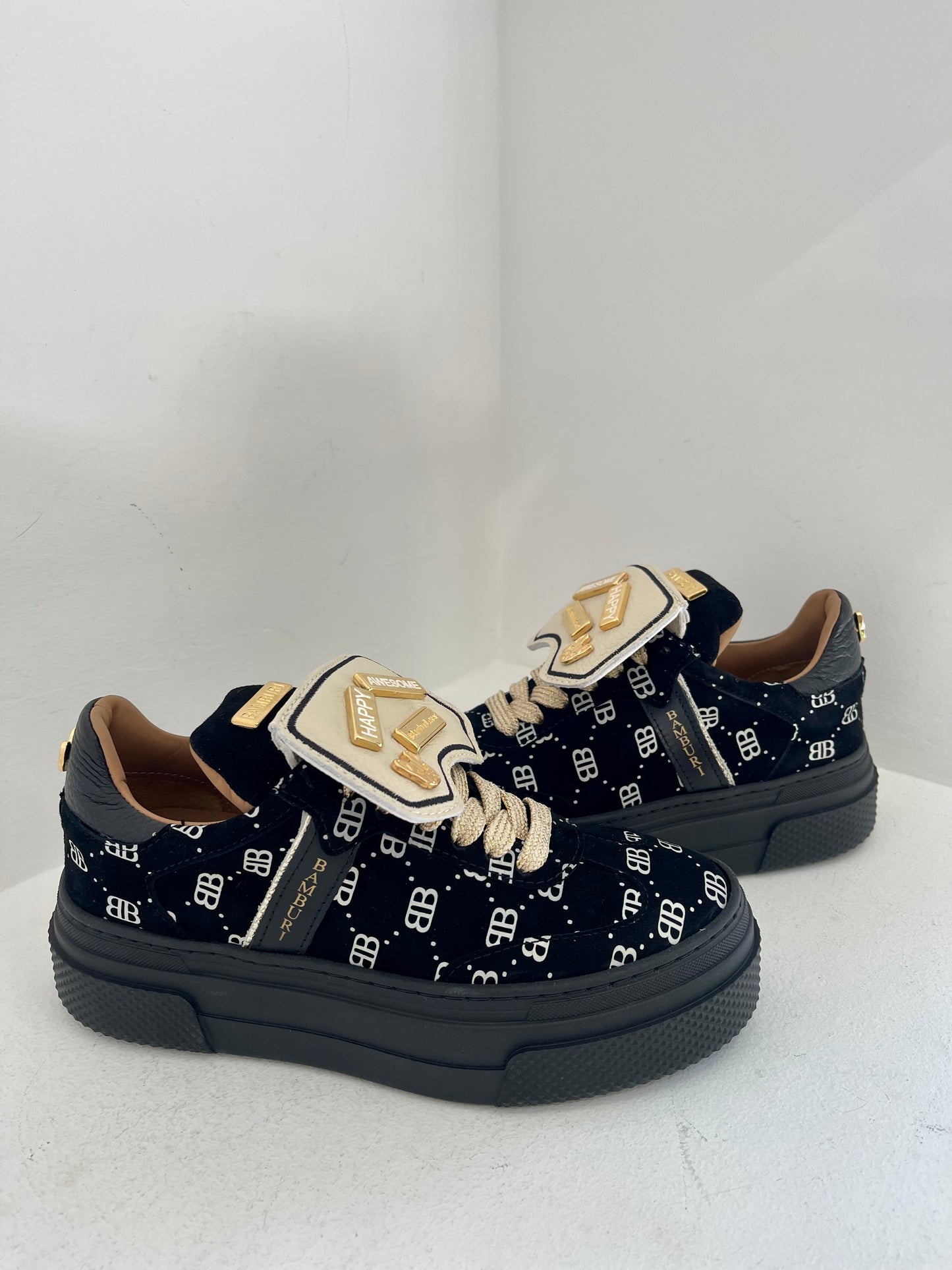 Black sneaker with gold details