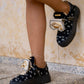 Black sneaker with gold details