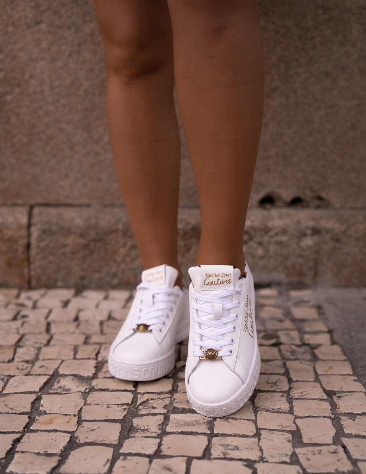 White sneaker with gold lettering