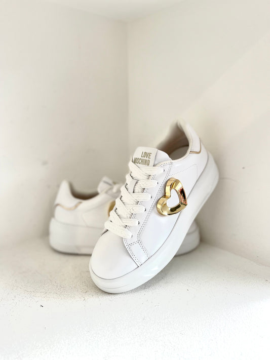 White sneaker with gold heart