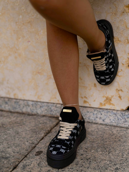 Black sneaker with gold details